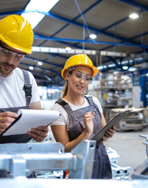 factory-workers-checking-quality-products-large-industrial-hall