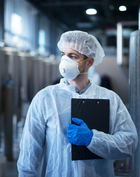 technologist-protective-white-suit-with-hairnet-mask-standing-food-factory